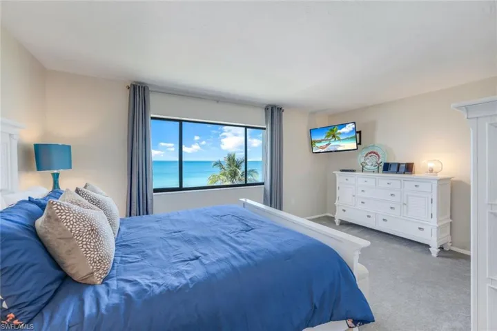 Bedroom featuring carpet and a water view