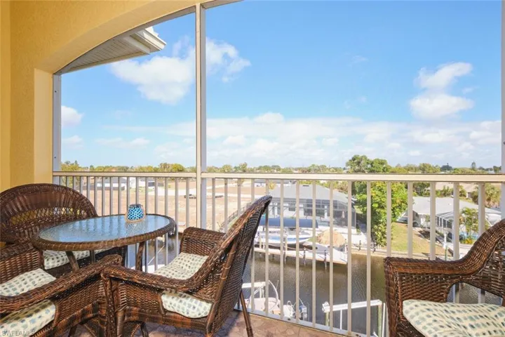Balcony featuring a water view and a sunroom