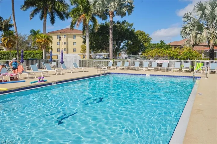 Community pool with a patio
