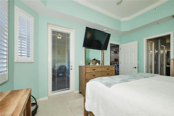Bedroom featuring crown molding and light tile patterned floors