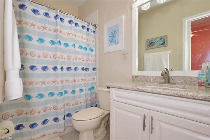 Full bath with vanity and a shower with shower curtain