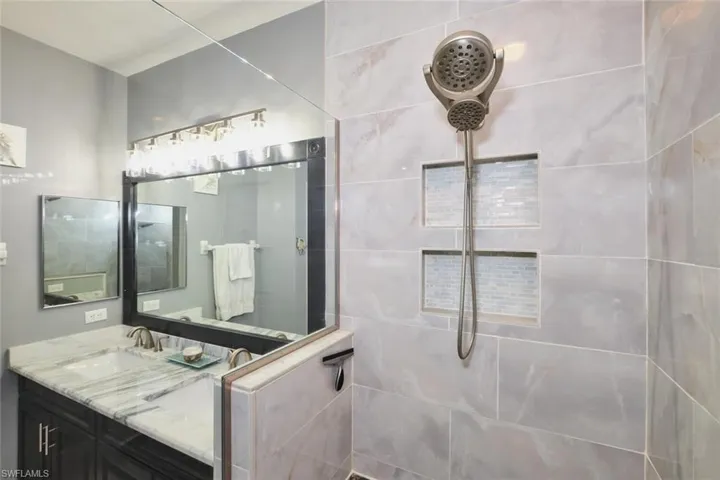 Bathroom featuring vanity and a walk in shower