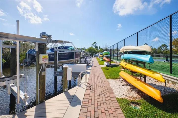 Dock featuring boat lift and a water view