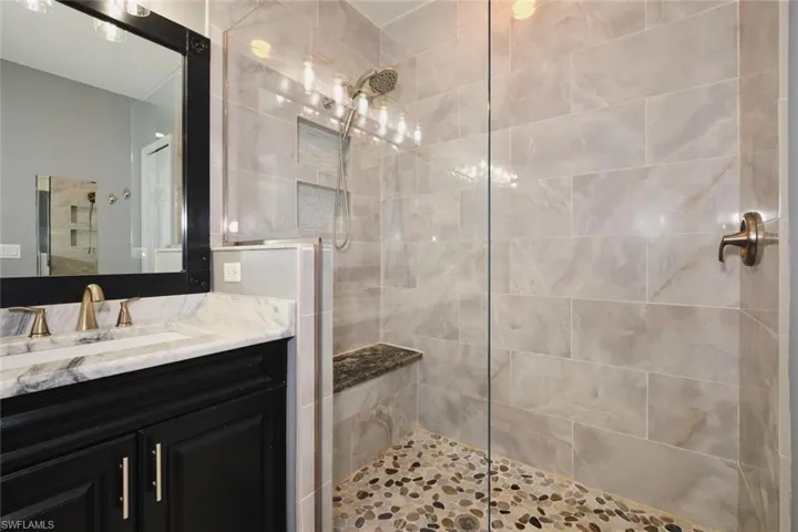 Bathroom with vanity and a walk in shower