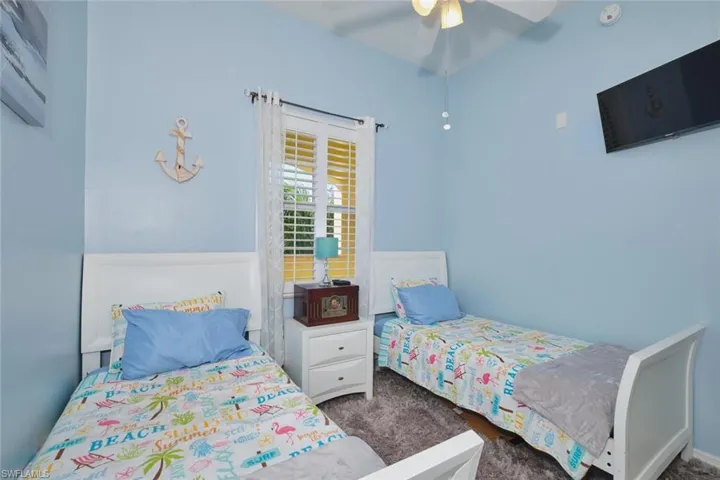 Bedroom featuring dark colored carpet and ceiling fan