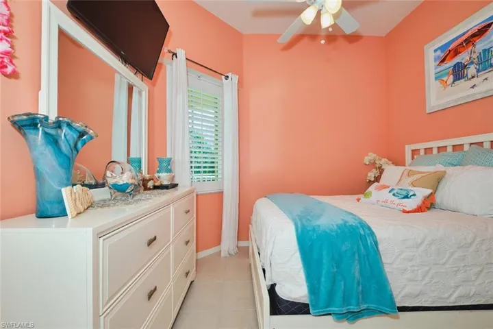 Bedroom with ceiling fan and light tile patterned floors