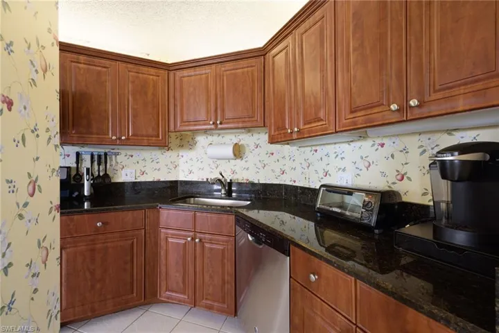 Kitchen featuring appliances with stainless steel finishes and granite countertops