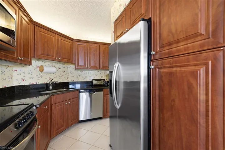 Kitchen featuring appliances with stainless steel finishes and granite countertops