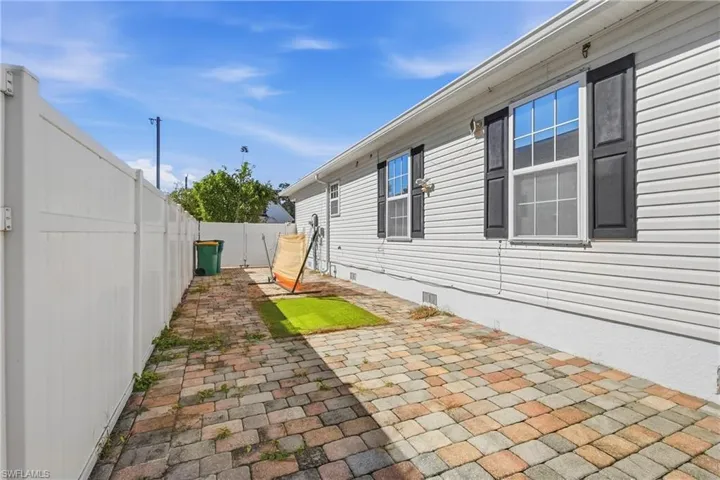View of side of property featuring crawl space, a patio area, and a fenced backyard