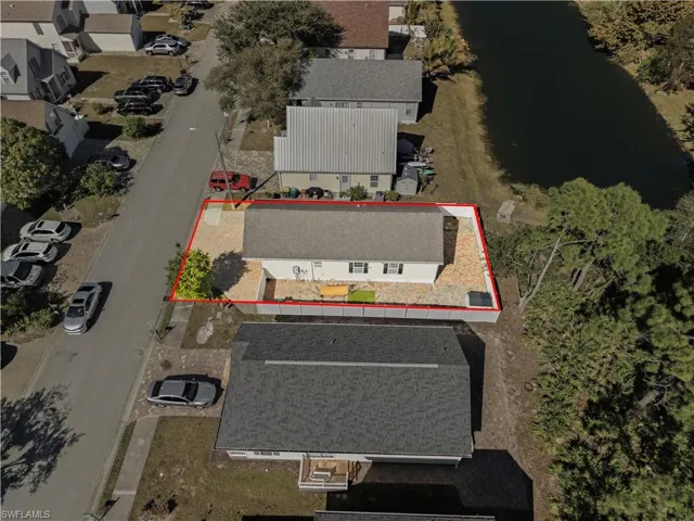 Aerial view of property's location with a nearby body of water and property boundaries highlighted