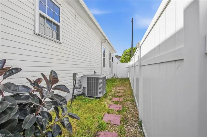 View of home's exterior with a cooling unit
