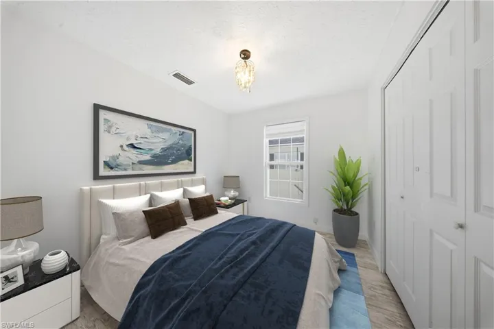 Bedroom featuring a closet and a chandelier