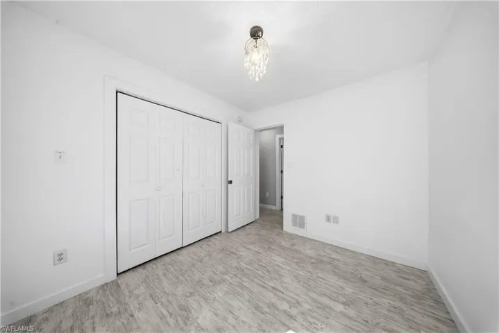 Unfurnished bedroom featuring a closet and wood finished floors