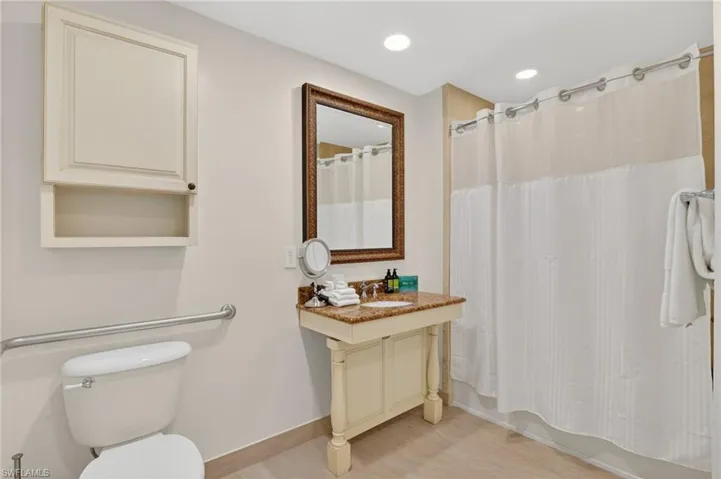 Bathroom with vanity, recessed lighting, and shower / bath combo with shower curtain