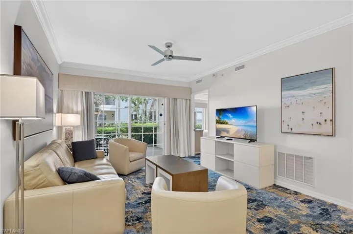 Living area with ornamental molding and ceiling fan