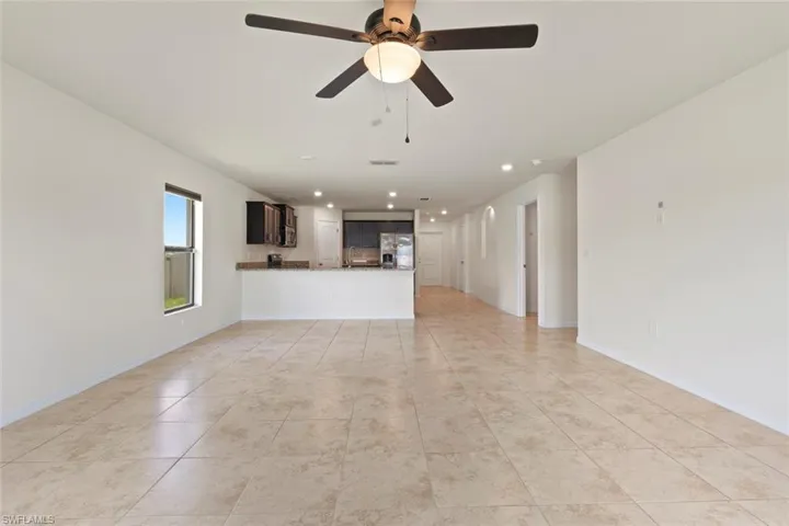 Unfurnished living room with light tile patterned floors, recessed lighting, and a ceiling fan