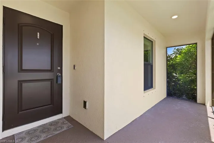 View of exterior entry with stucco siding