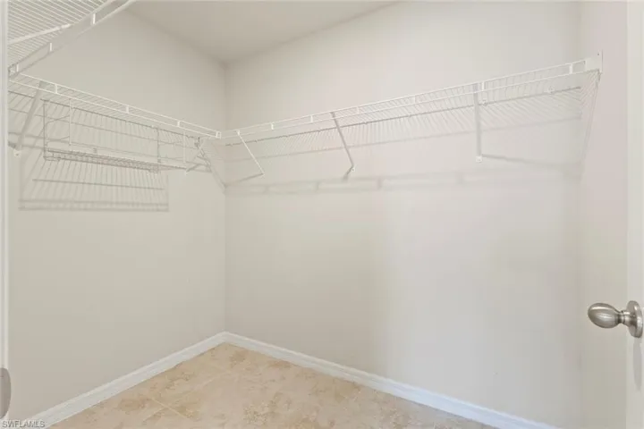 Spacious closet featuring light tile patterned floors