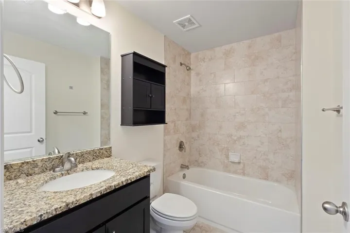 Full bath featuring bathtub / shower combination and vanity