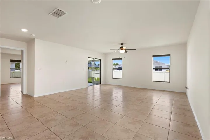 Spare room with light tile patterned floors and a ceiling fan