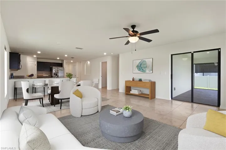 Living area featuring recessed lighting, light tile patterned floors, and ceiling fan