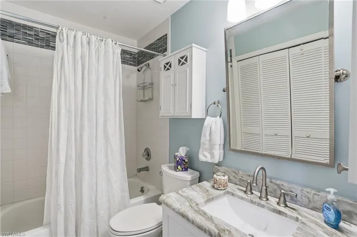 Full bath with shower / bathtub combination with vanity, and a laundry closet