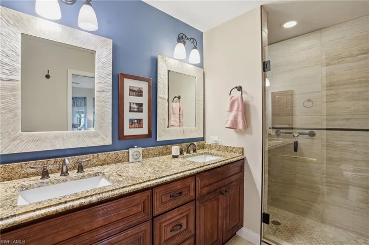Full bath with granite  double vanity and a tilrd shower.