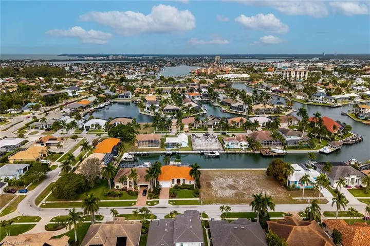 Aerial overview of property's location featuring nearby suburban area and a nearby body of water