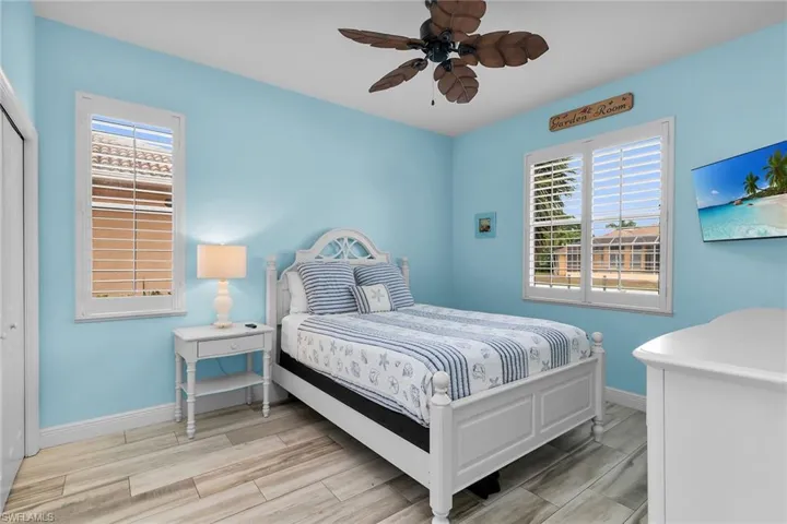 Bedroom with wood tiled floors and ceiling fan