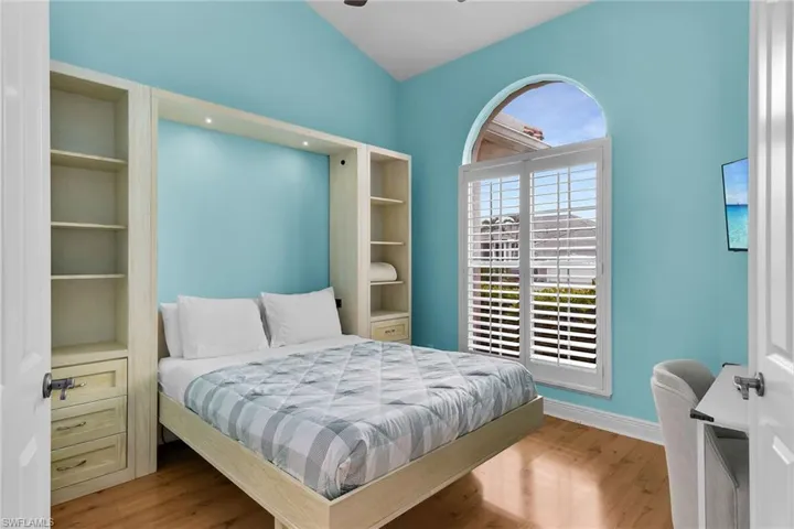 Bedroom featuring wood finished floors and lofted ceiling