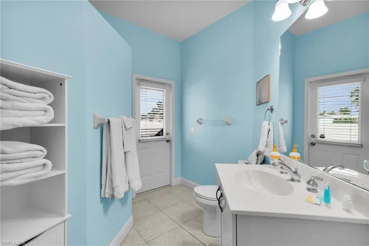 Half bath featuring vanity and light tile patterned floors