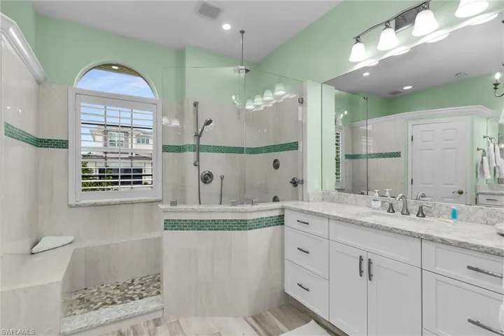 Bathroom featuring vanity and a walk in shower