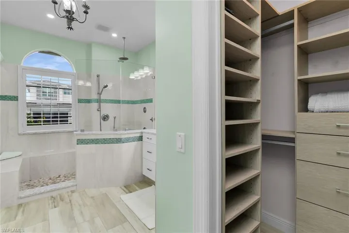 Bathroom featuring a walk in shower and vanity