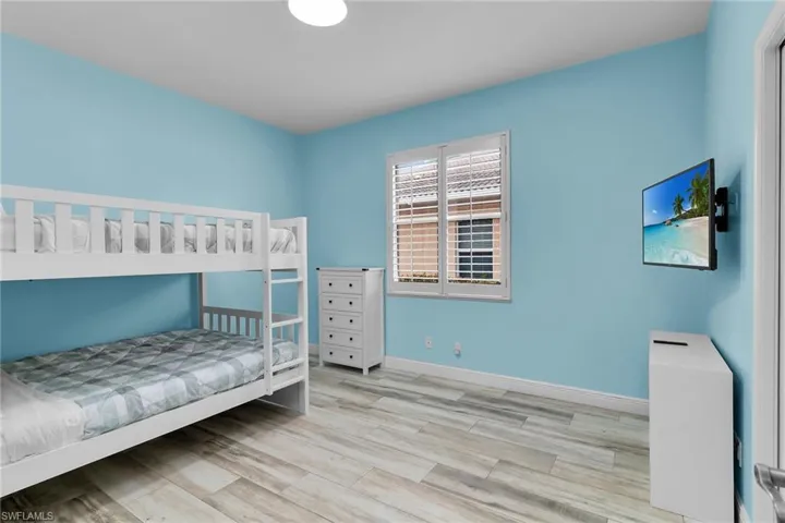 Bedroom with light wood finished floors and baseboards