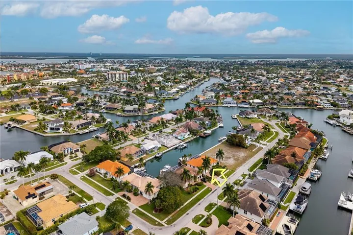 Aerial overview of property's location with nearby suburban area and a nearby body of water