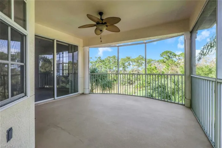 Unfurnished sunroom with ceiling fan and a balcony