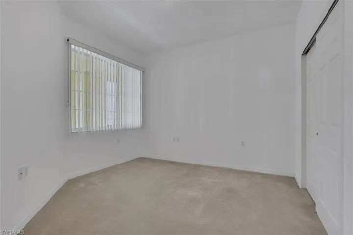 Unfurnished bedroom featuring a closet and light carpet