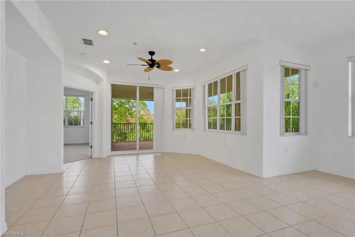 Empty room featuring healthy amount of natural light, recessed lighting, ceiling fan, and light tile patterned flooring