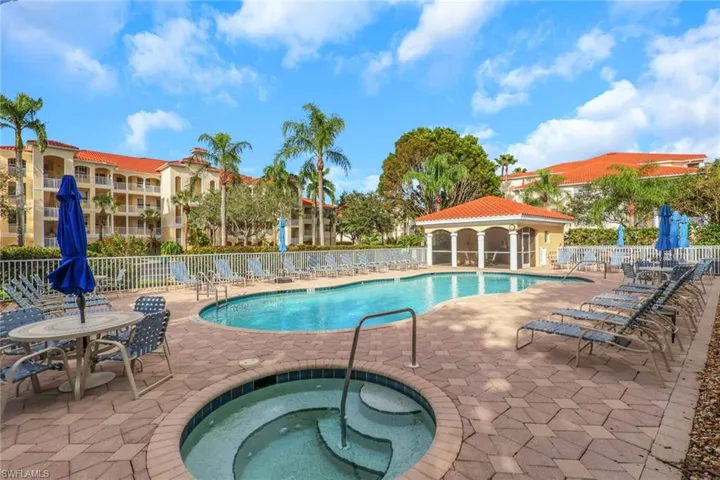 Community pool featuring a patio area, a hot tub, and a gazebo