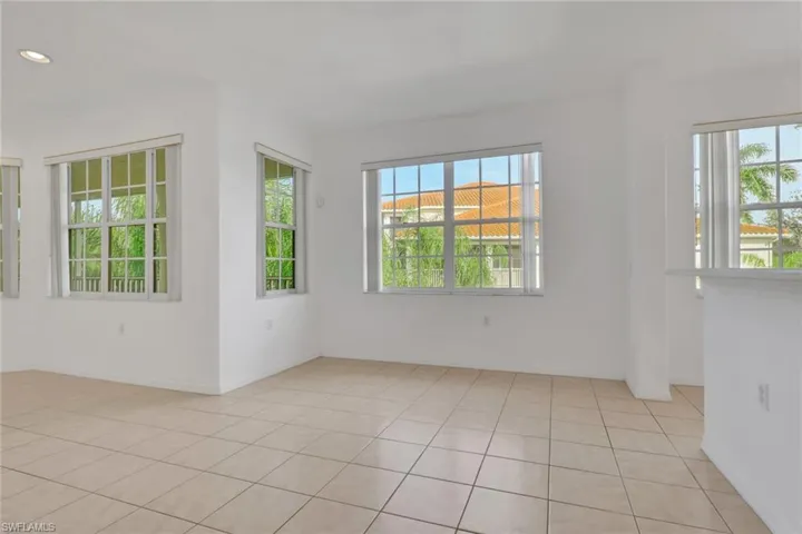 Spare room with healthy amount of natural light and light tile patterned floors