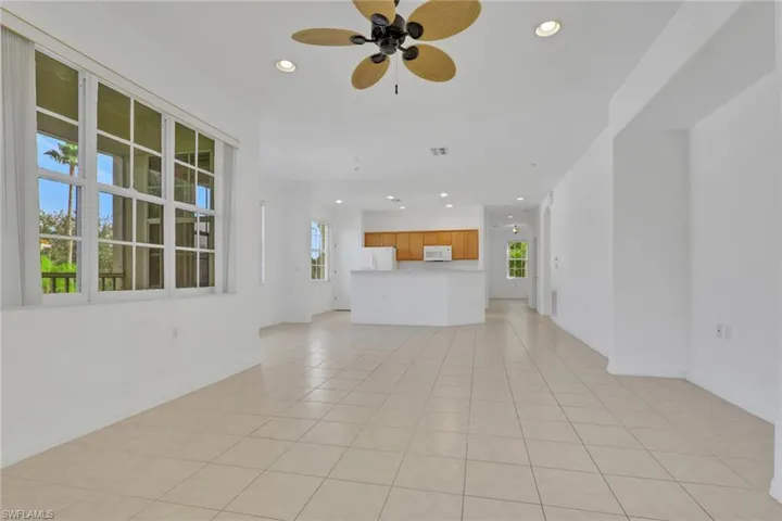 Unfurnished living room with recessed lighting, light tile patterned floors, and a ceiling fan