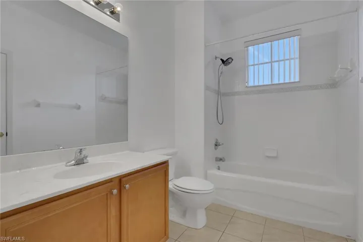 Full bathroom featuring vanity, bathtub / shower combination, and light tile patterned flooring