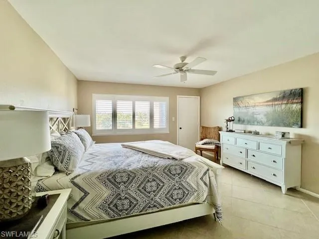 Tiled bedroom with ceiling fan