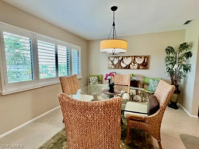Dining area with light colored carpet