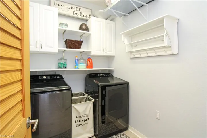 Laundry area with cabinets and separate washer and dryer