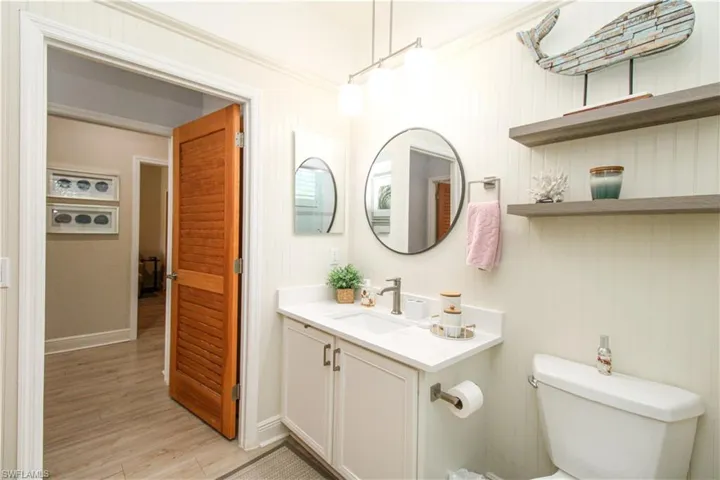 Bathroom with vanity, toilet, and hardwood / wood-style floors