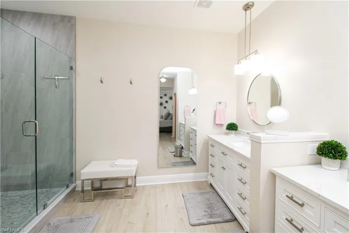 Bathroom with vanity, hardwood / wood-style floors, and walk in shower