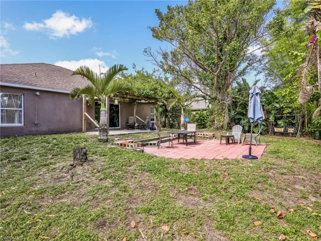 View of green lawn featuring a patio