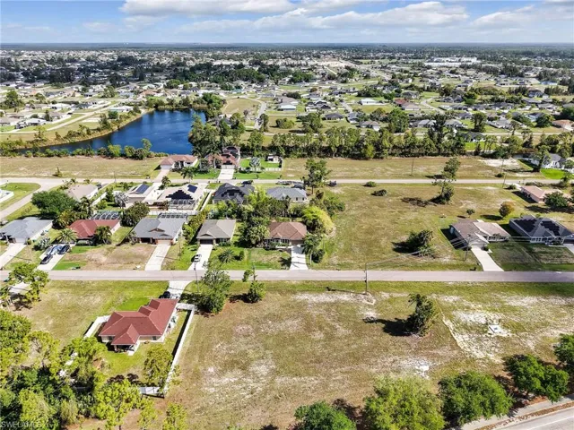 Aerial overview of property's location featuring nearby suburban area and a large body of water