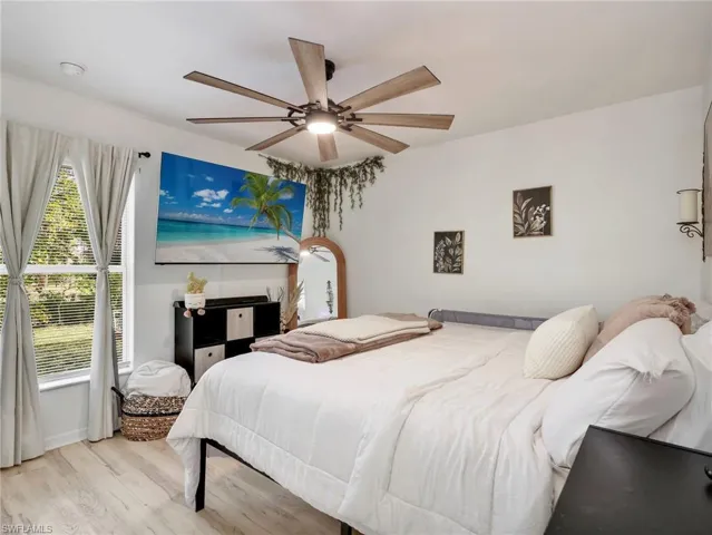 Bedroom featuring light wood-type flooring and ceiling fan